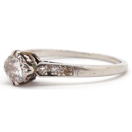 3003 - A platinum diamond solitaire ring with diamond set shoulders, the diamond approximately 4.89mm in di... 