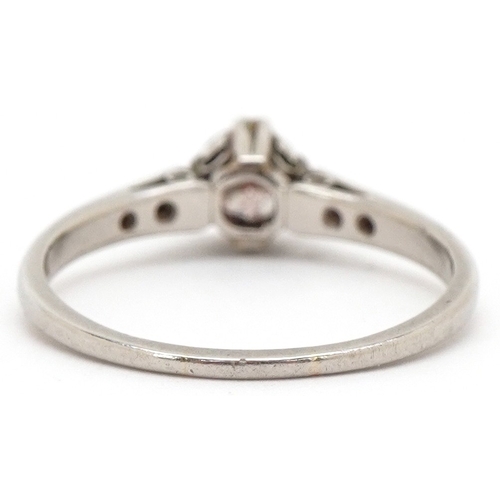3003 - A platinum diamond solitaire ring with diamond set shoulders, the diamond approximately 4.89mm in di... 