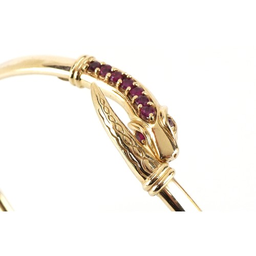 3055 - A 9ct gold and pink spinel bracelet in the form of a serpent, 6cm in diameter, 7.4g.