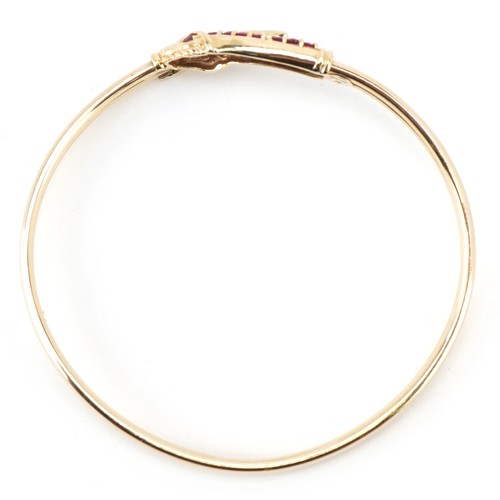 3055 - A 9ct gold and pink spinel bracelet in the form of a serpent, 6cm in diameter, 7.4g.