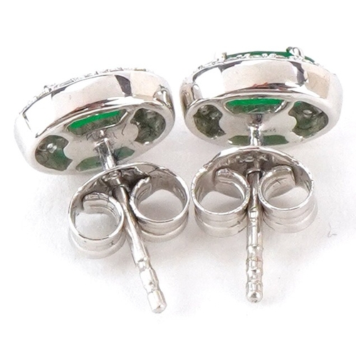 3036 - A pair of 18ct white gold emerald and diamond cluster stud earrings, total emerald weight approximat... 