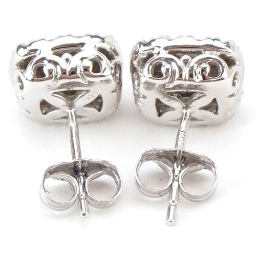 3046 - A pair of 14ct white gold diamond cluster stud earrings, total diamond weight approximately 1.00 car... 