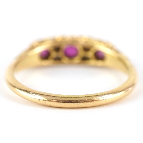 3017 - An 18ct gold diamond and graduated ruby half eternity ring with ornate shoulders housed in a Laqui &... 
