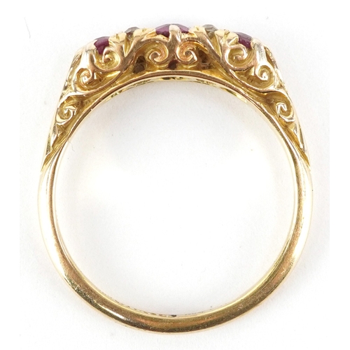 3017 - An 18ct gold diamond and graduated ruby half eternity ring with ornate shoulders housed in a Laqui &... 