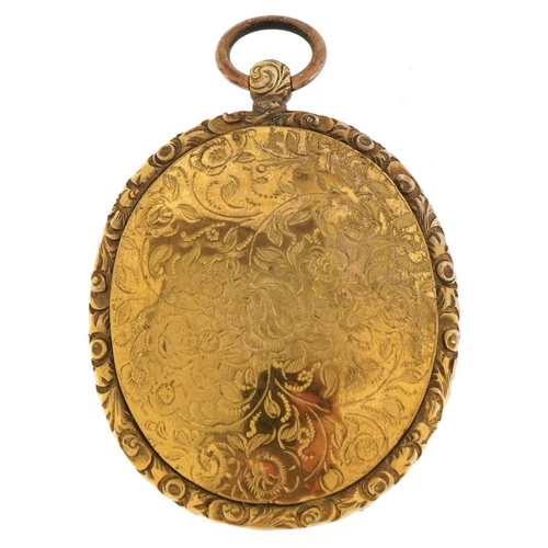 3010A - A large antique gilt metal locket with floral engraved decoration, 6.2cm high, 29.0g.