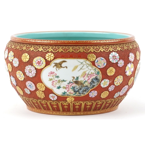 54 - A large Chinese porcelain jardinière, finely hand painted in the famille rose palette with panels of... 