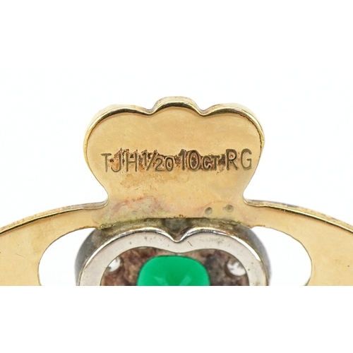 3029 - A gold plated emerald and white stone Claddagh hinged bangle, 6cm wide, 12.2g.