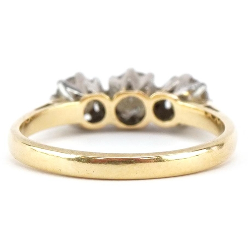 3031A - An 18ct gold diamond three stone ring, total diamond weight approximately 0.70 carat, size L, 2.8g.