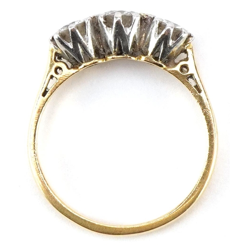 3031A - An 18ct gold diamond three stone ring, total diamond weight approximately 0.70 carat, size L, 2.8g.