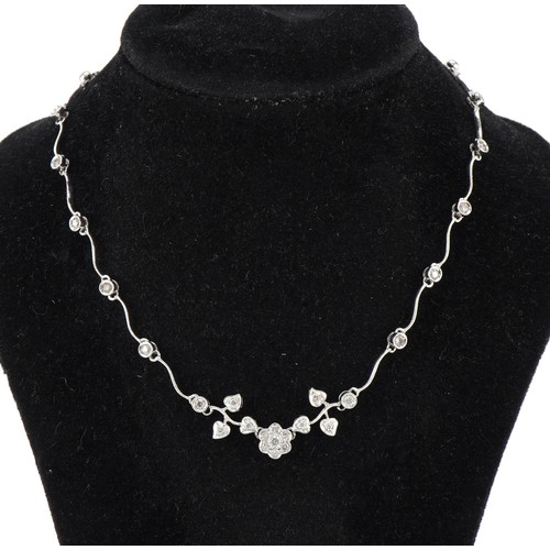 3010 - An 18ct white gold diamond floral necklace, the largest diamond approximately 0.12 carat, 35cm in le... 