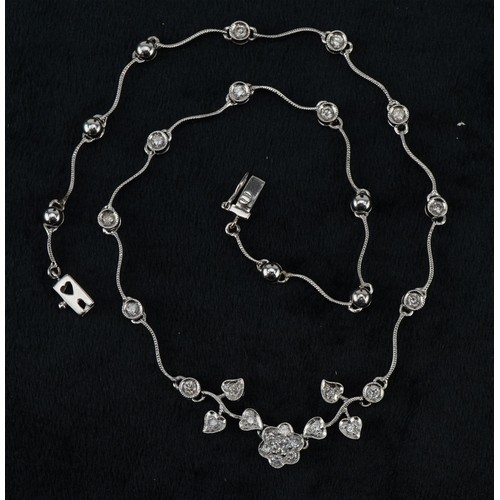 3010 - An 18ct white gold diamond floral necklace, the largest diamond approximately 0.12 carat, 35cm in le... 