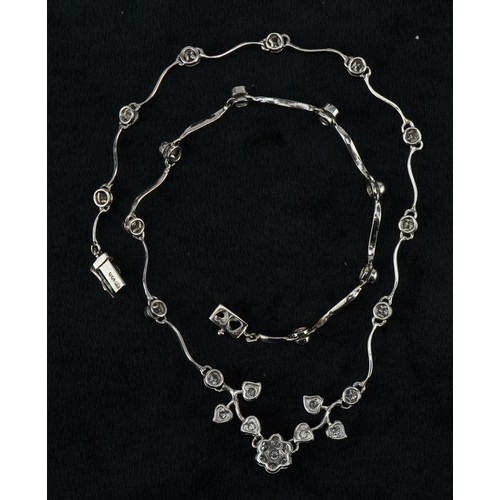 3010 - An 18ct white gold diamond floral necklace, the largest diamond approximately 0.12 carat, 35cm in le... 