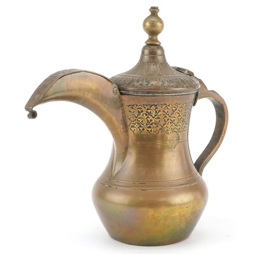 A Middle Eastern Omani brass dallah coffee pot with engraved decoration, 20cm high.