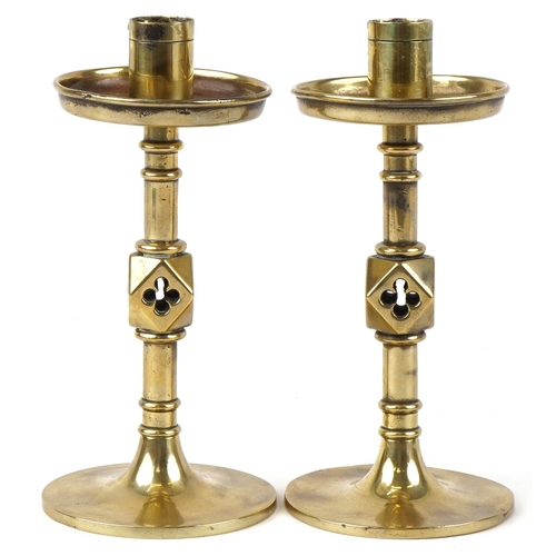 8 - A pair of late 19th century ecclesiastical brass candlesticks on circular bases, 20cm high.
