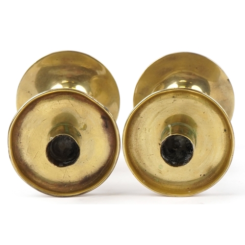 8 - A pair of late 19th century ecclesiastical brass candlesticks on circular bases, 20cm high.