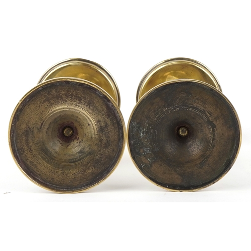 8 - A pair of late 19th century ecclesiastical brass candlesticks on circular bases, 20cm high.