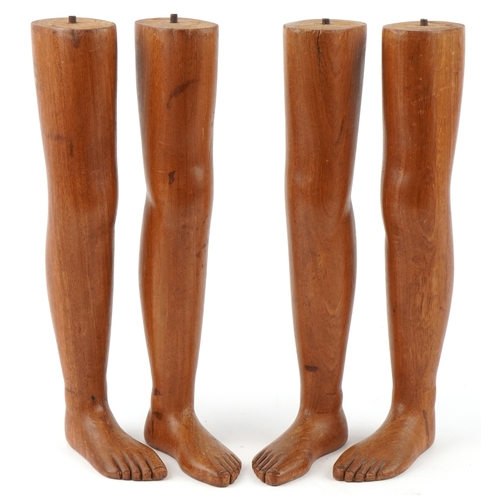 Four novelty carved mahogany table legs in the form of a child's legs, 40cm in length.