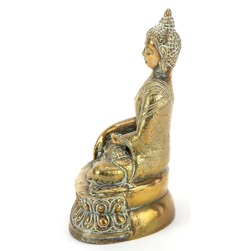43 - A Tibetan polished brass figure of Buddha, 15cm high.