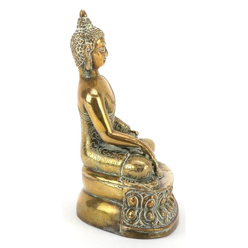 43 - A Tibetan polished brass figure of Buddha, 15cm high.