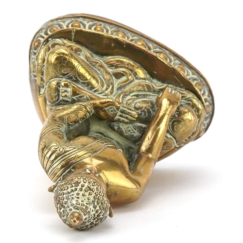 43 - A Tibetan polished brass figure of Buddha, 15cm high.