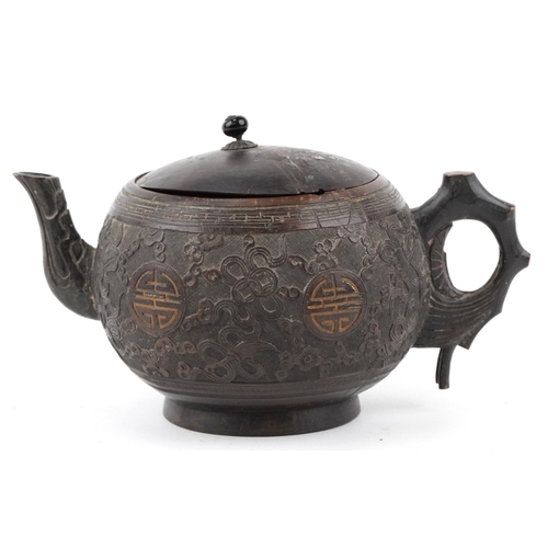 59 - A Chinese carved coconut teapot decorated with scrolling foliage, 10cm high.