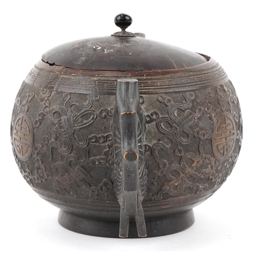 59 - A Chinese carved coconut teapot decorated with scrolling foliage, 10cm high.