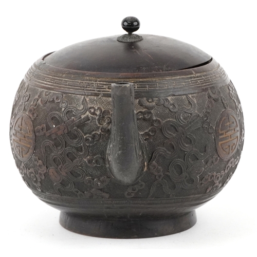 59 - A Chinese carved coconut teapot decorated with scrolling foliage, 10cm high.