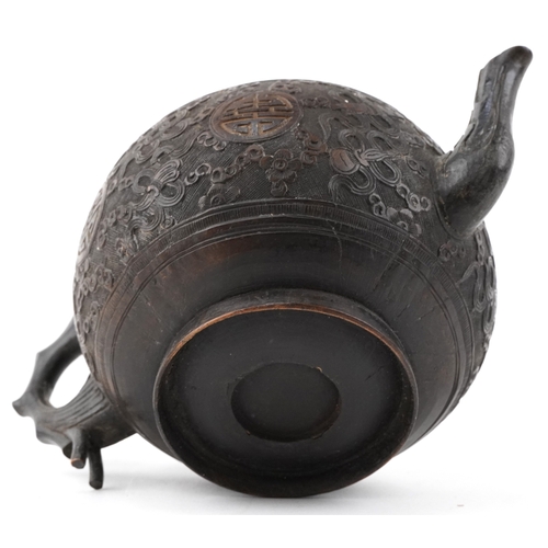 59 - A Chinese carved coconut teapot decorated with scrolling foliage, 10cm high.
