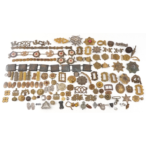 1285 - A large collection of military interest badges and belt buckles.
