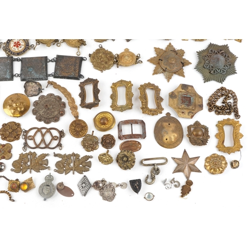 1285 - A large collection of military interest badges and belt buckles.