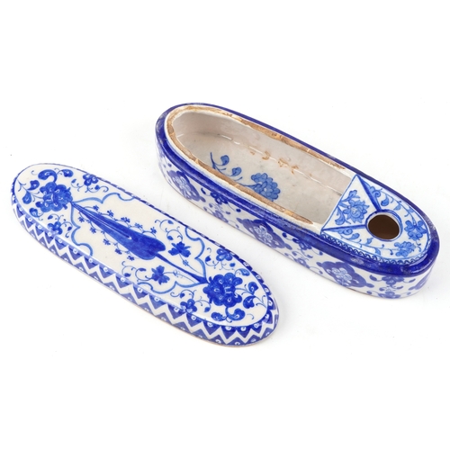 52 - A Turkish Ottoman Iznik pen box hand painted with flowers and stylized motifs, 31cm in length.