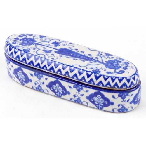 52 - A Turkish Ottoman Iznik pen box hand painted with flowers and stylized motifs, 31cm in length.
