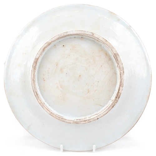 55 - A Turkish Ottoman Iznik plate hand painted with flowers and stylized motifs, 30cm in diameter.