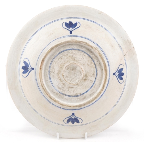 49 - A Turkish Ottoman Iznik plate decorated with flowers and stylized motifs, 31cm in diameter.