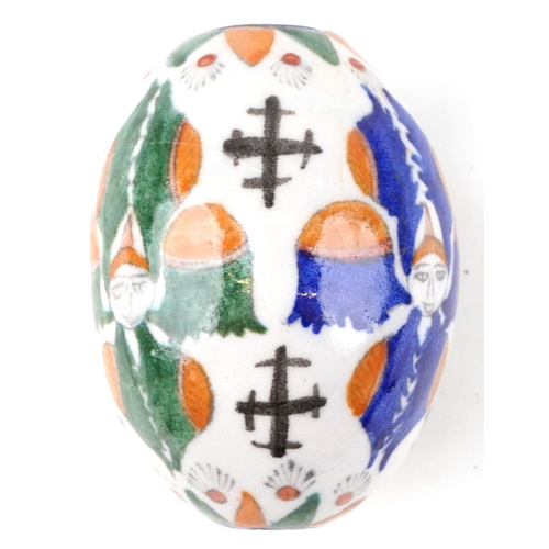 54 - A Turkish Armenian pottery hanging ball hand painted with mythical faces and motifs, 10cm high.