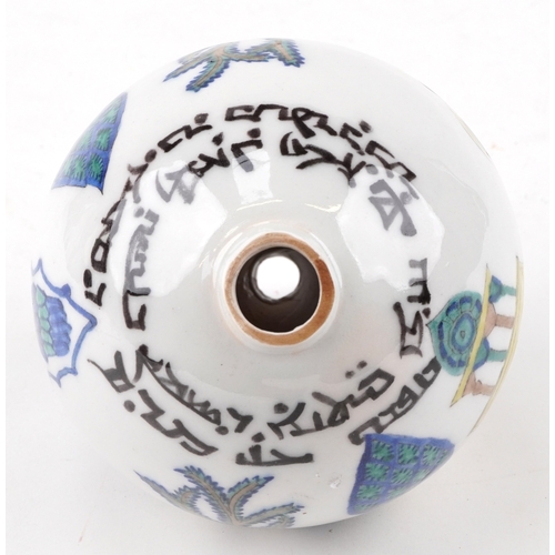 57 - A Turkish Ottoman Kutahya hanging ball hand painted with biblical figures, 20cm high.