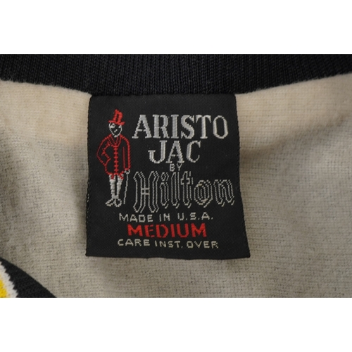 559 - The Executioner's Song (1982), a black crew jacket with white printed back and yellow striped cuffs,... 