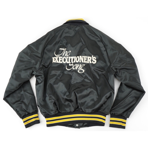 559 - The Executioner's Song (1982), a black crew jacket with white printed back and yellow striped cuffs,... 