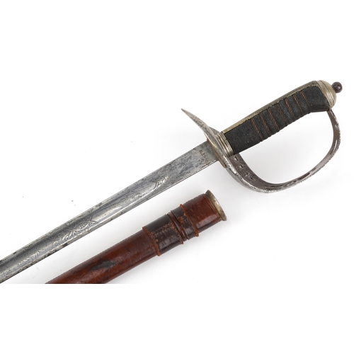 1308 - A British military World War I sword and scabbard with wire bound shagreen grip, the steel blade eng... 