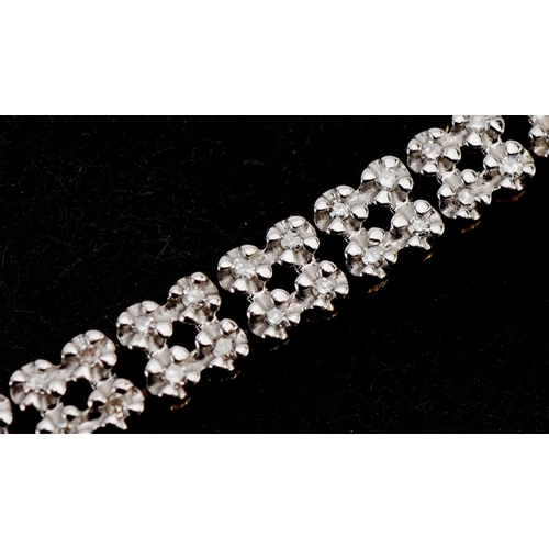 3020 - A 9ct gold diamond two line bracelet, 20cm in length, 8.3g.