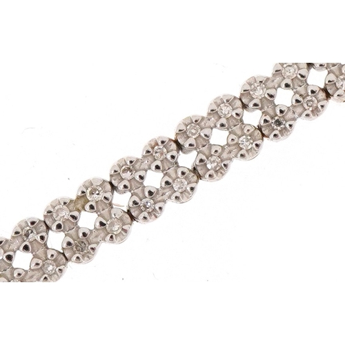 3020 - A 9ct gold diamond two line bracelet, 20cm in length, 8.3g.