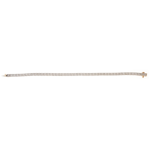 3020 - A 9ct gold diamond two line bracelet, 20cm in length, 8.3g.