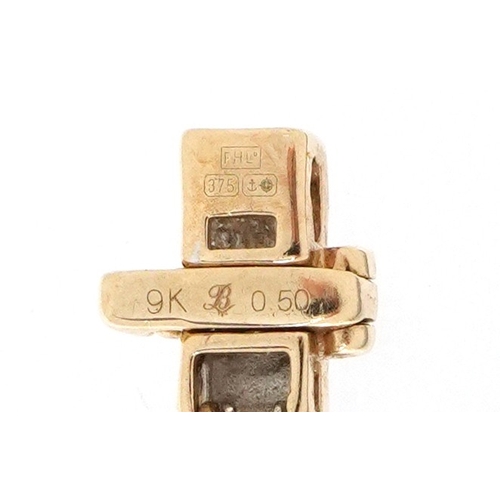 3020 - A 9ct gold diamond two line bracelet, 20cm in length, 8.3g.