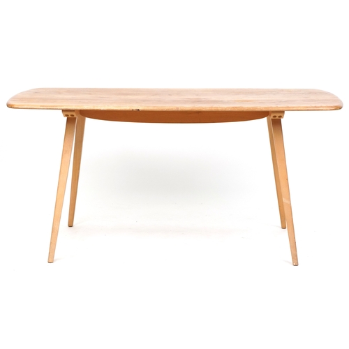 An Ercol beech and elm rectangular dining table on tapering legs, 71cm H x 150cm L x 74cm D.