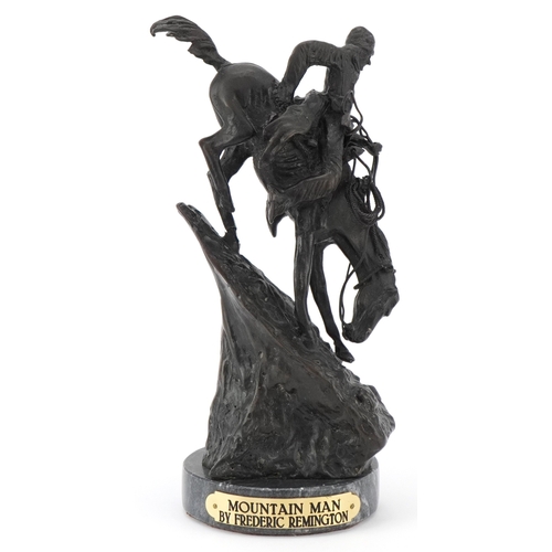 Frederic Remington - Mountain Man, a 20th century bronze figure of a Native American descending a slope on a horse, 27cm high.