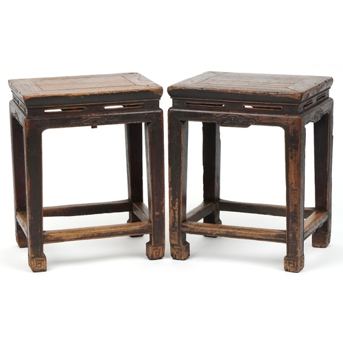 A pair of Chinese elm tables, late 19th/early 20th century, the rectangular tops raised on block legs united by stretchers, 53cm H x 42cm W x 33cm D.