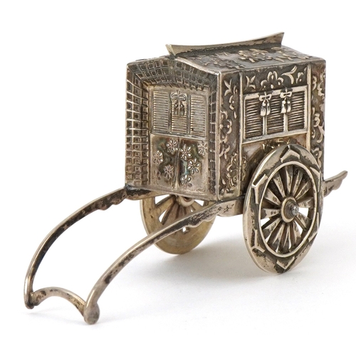 65 - A novelty Japanese sterling silver caster in the form of a rickshaw with rotating wheels, 6.5cm in l... 