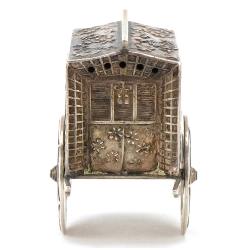 65 - A novelty Japanese sterling silver caster in the form of a rickshaw with rotating wheels, 6.5cm in l... 