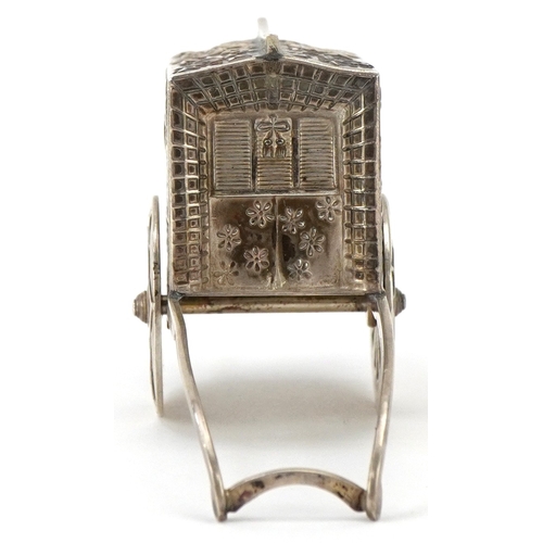 65 - A novelty Japanese sterling silver caster in the form of a rickshaw with rotating wheels, 6.5cm in l... 