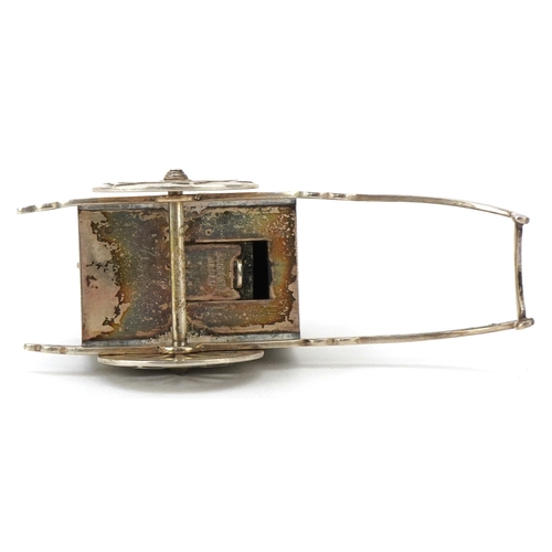 65 - A novelty Japanese sterling silver caster in the form of a rickshaw with rotating wheels, 6.5cm in l... 